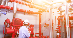 a man assessing pipes of a fire sprinkler system 