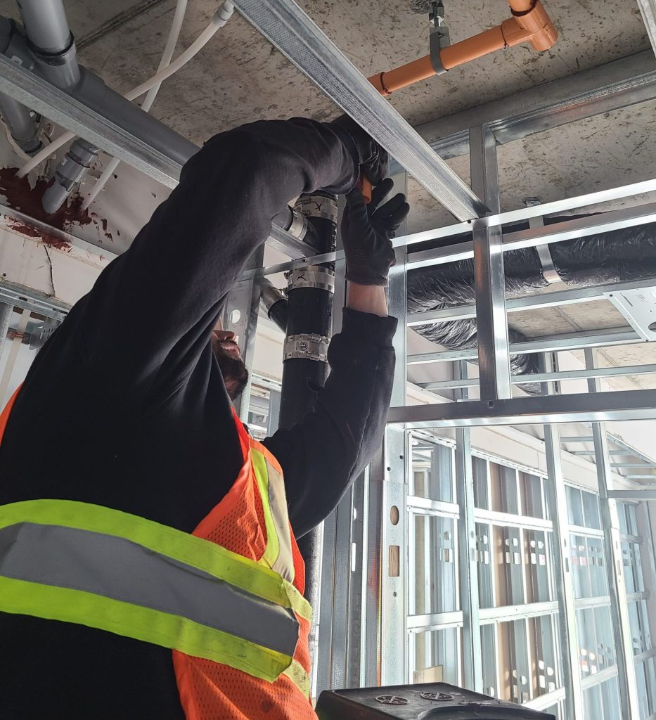 A man working on a fire sprinkler